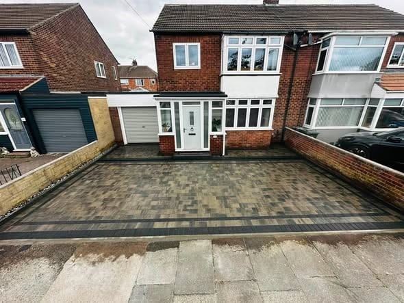 A new block paved driveway at the front of a house