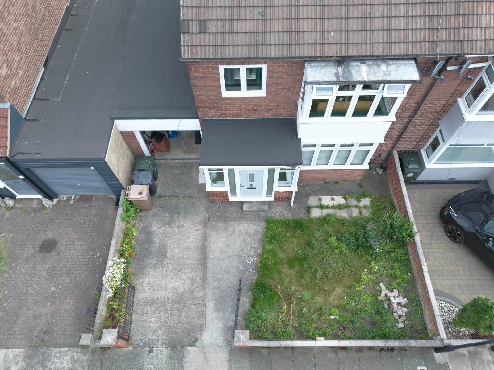 A front garden before and after a new block paved driveway, from the air