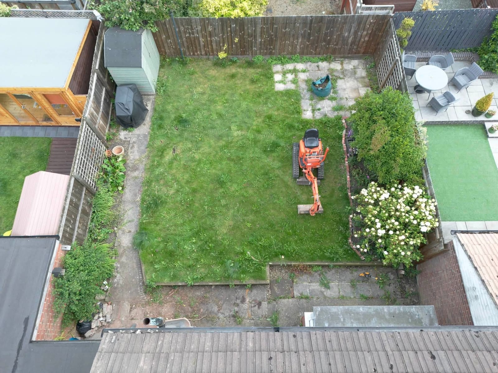 A back garden from the air, before and after a new porcelain patio and lawn