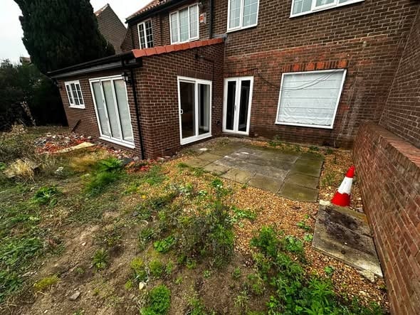 The garden before work started, overgrown and uneven